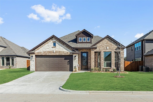 view of front of house featuring cooling unit, a front lawn, and a garage