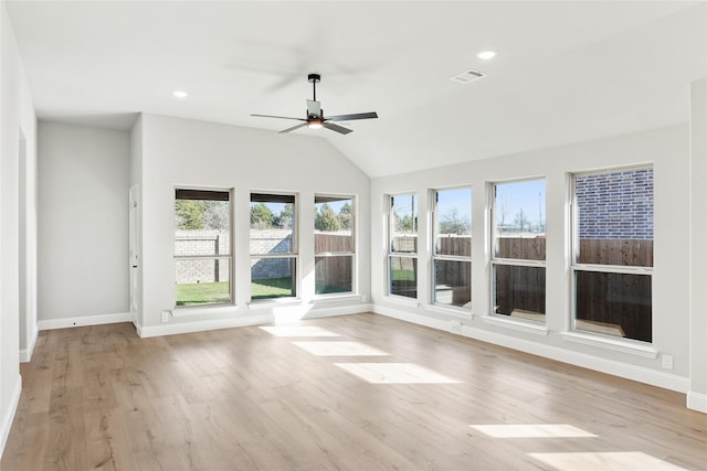 unfurnished sunroom featuring ceiling fan and vaulted ceiling