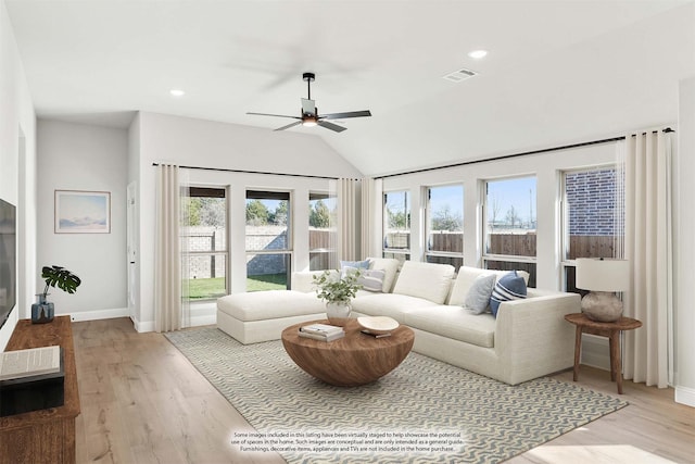 living room featuring lofted ceiling, light wood-type flooring, and ceiling fan