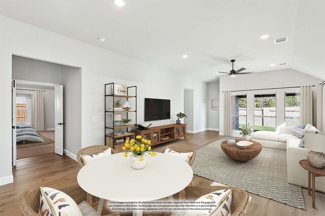 living room featuring ceiling fan, vaulted ceiling, and hardwood / wood-style floors