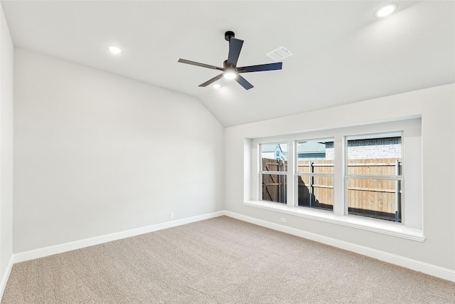 unfurnished room featuring ceiling fan, vaulted ceiling, and carpet flooring