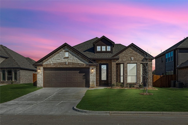 view of front facade with a yard and a garage