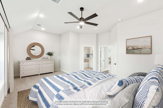 bedroom with vaulted ceiling, ensuite bathroom, light colored carpet, and ceiling fan