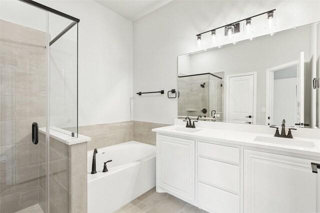 bathroom featuring separate shower and tub, wood-type flooring, and vanity