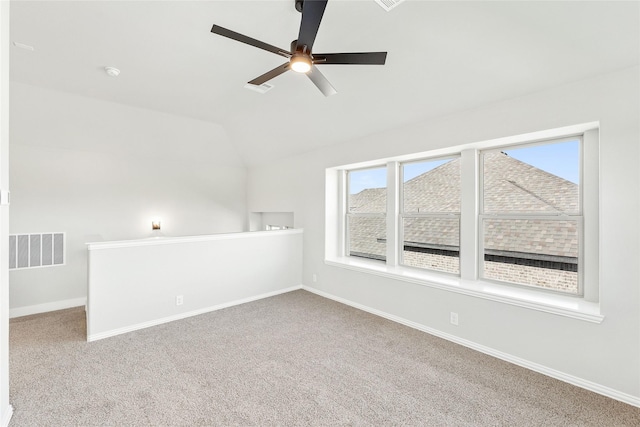 unfurnished room with lofted ceiling, carpet floors, and ceiling fan