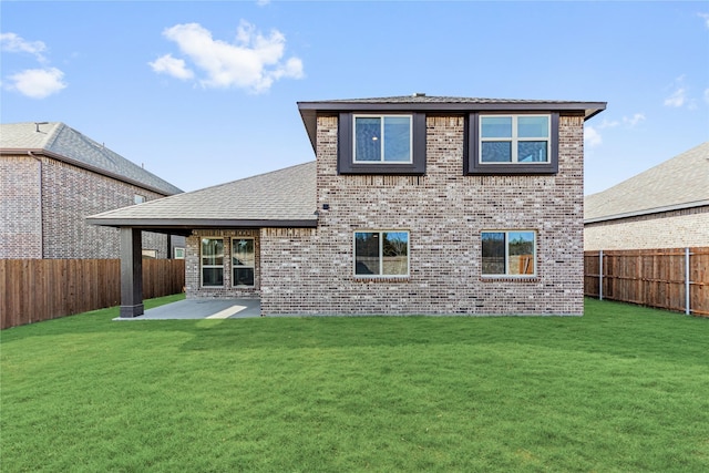 rear view of property featuring a patio and a yard