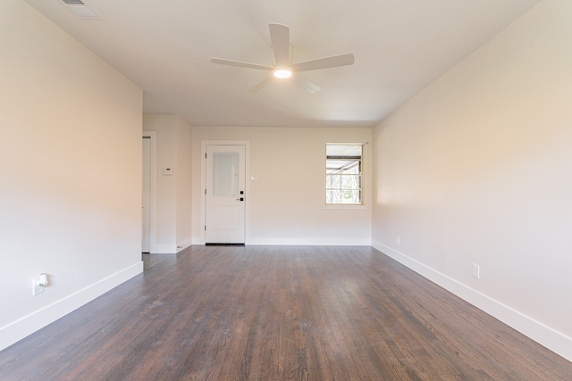 empty room featuring ceiling fan and dark wood-type flooring