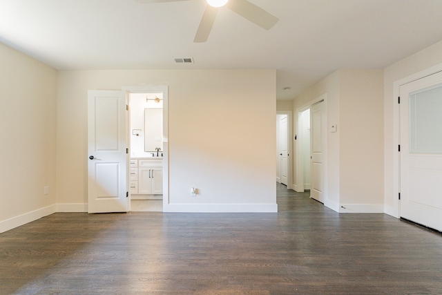 empty room featuring ceiling fan, sink, and dark hardwood / wood-style flooring