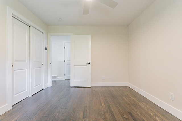 unfurnished bedroom featuring a closet, dark hardwood / wood-style flooring, and ceiling fan