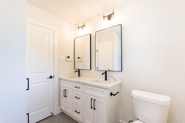 bathroom with vanity, toilet, and tile patterned floors