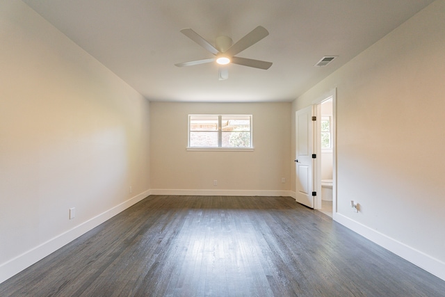 spare room with dark hardwood / wood-style floors and ceiling fan