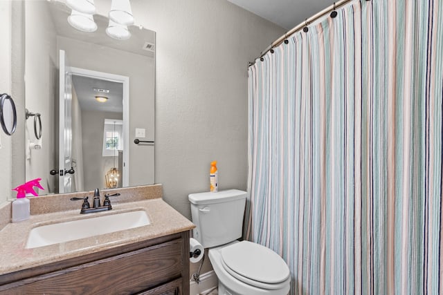 bathroom featuring vanity, toilet, and a shower with shower curtain