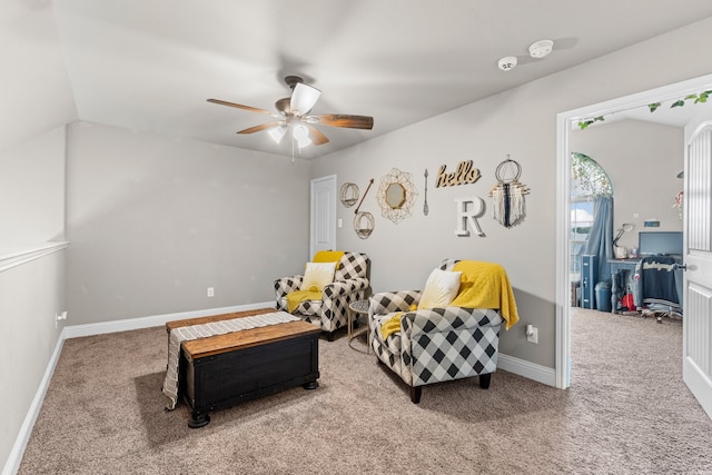 sitting room with carpet floors, vaulted ceiling, and ceiling fan