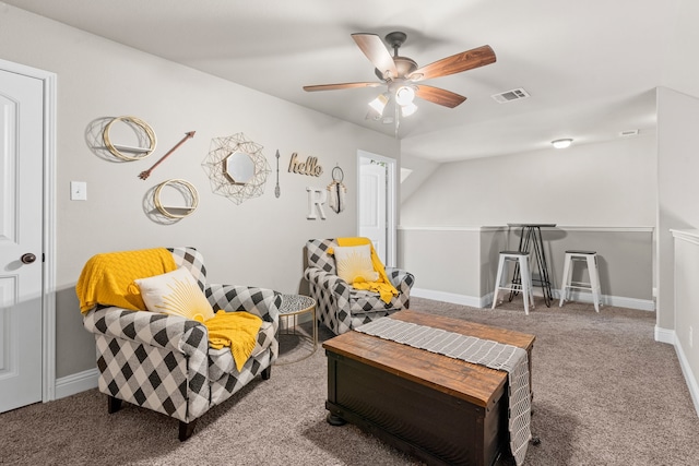 sitting room with ceiling fan and carpet flooring