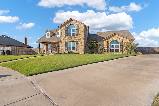 view of property featuring a front lawn