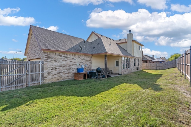 rear view of property featuring a patio, a yard, and cooling unit