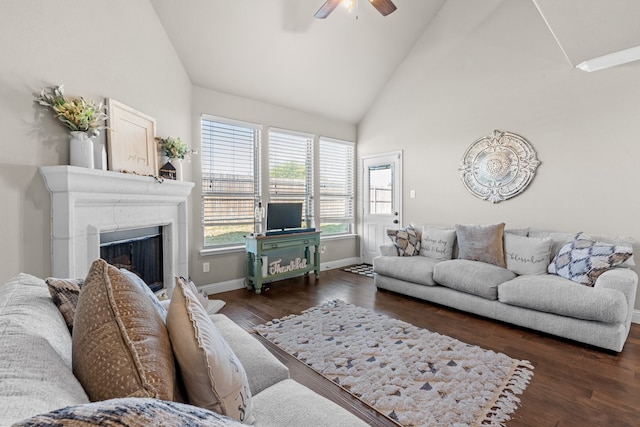 living room with ceiling fan, dark hardwood / wood-style flooring, and high vaulted ceiling