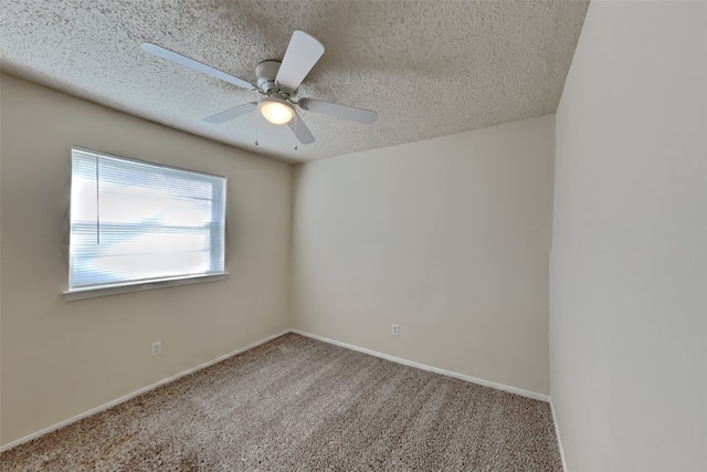 spare room featuring carpet floors, a textured ceiling, and ceiling fan