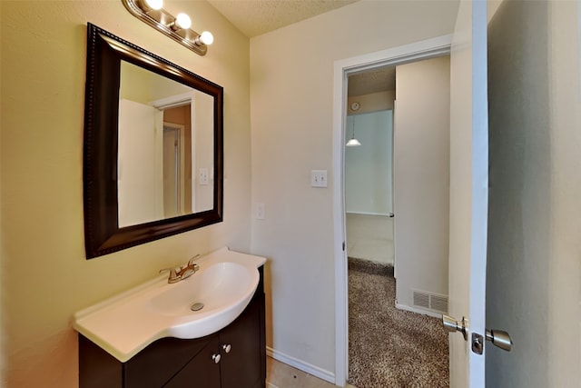 bathroom with vanity and a textured ceiling