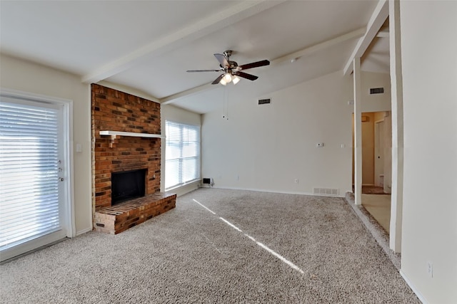 unfurnished living room featuring carpet floors, vaulted ceiling with beams, a fireplace, and ceiling fan