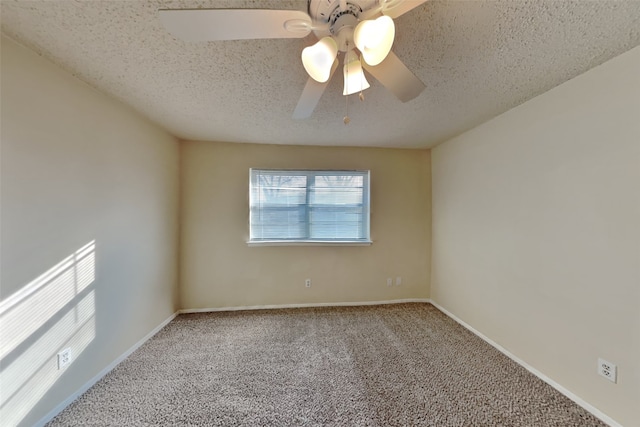 carpeted empty room featuring ceiling fan and a textured ceiling