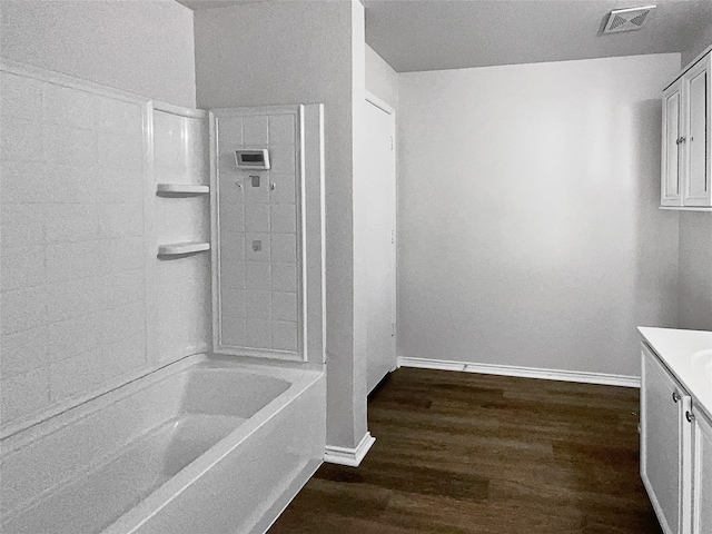 bathroom featuring vanity, tiled shower / bath combo, and hardwood / wood-style flooring