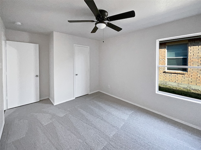 unfurnished bedroom with a closet, carpet, a textured ceiling, and ceiling fan