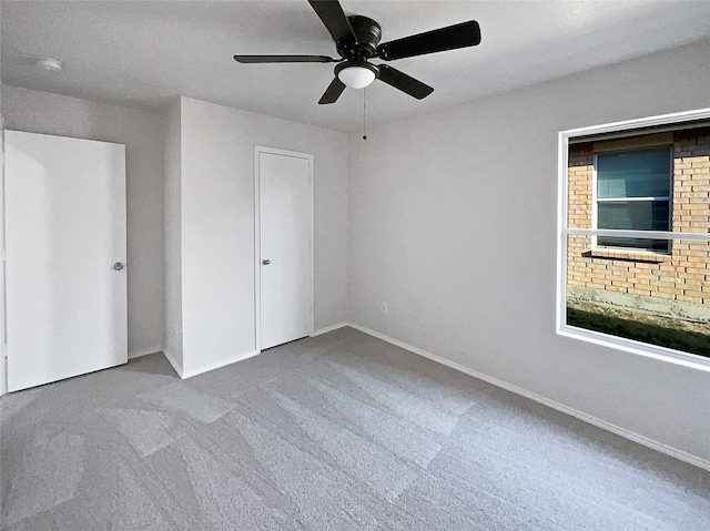 unfurnished bedroom with ceiling fan, carpet floors, and a closet