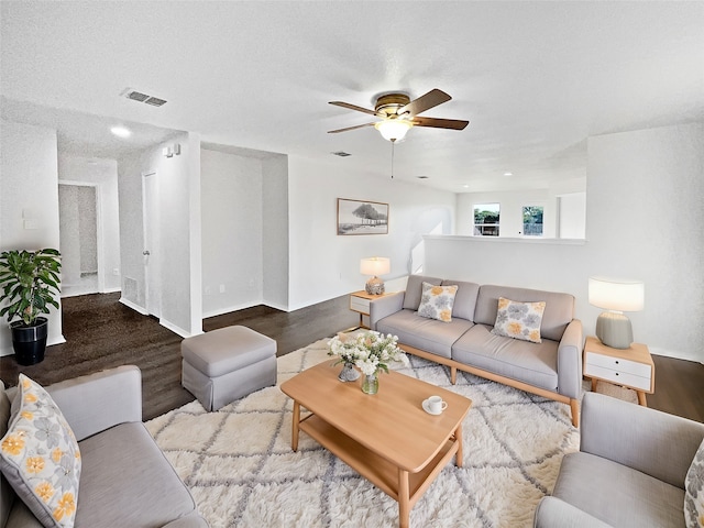 living room featuring ceiling fan, a textured ceiling, and hardwood / wood-style floors