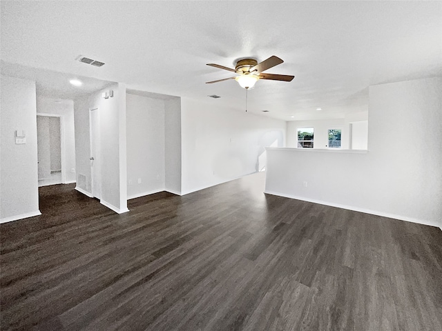 unfurnished living room with ceiling fan, dark wood-type flooring, and a textured ceiling