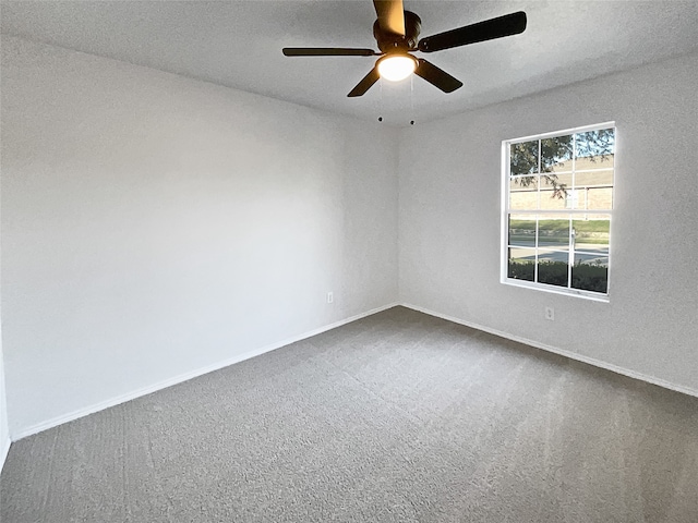 carpeted spare room featuring a textured ceiling and ceiling fan