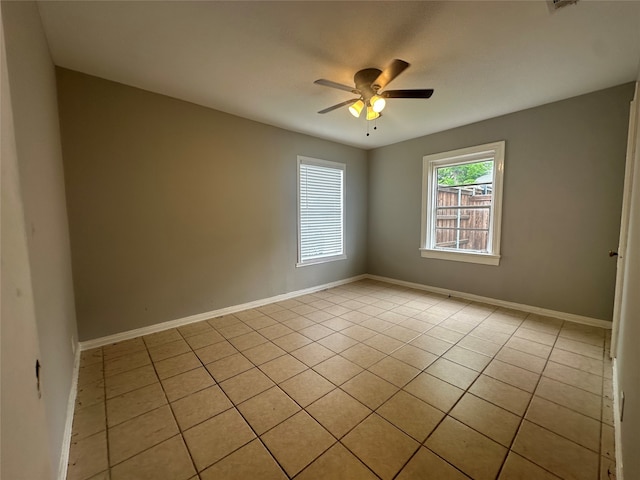 spare room featuring light tile patterned floors and ceiling fan