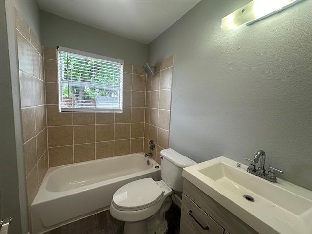 full bathroom featuring hardwood / wood-style floors, vanity, toilet, and tiled shower / bath combo