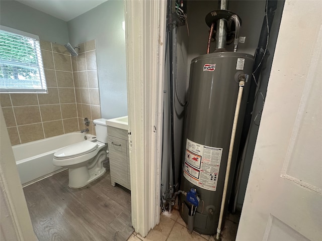 full bathroom featuring water heater, vanity, hardwood / wood-style flooring, shower / bath combo with shower curtain, and toilet