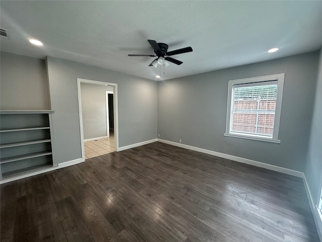 empty room featuring wood-type flooring and ceiling fan