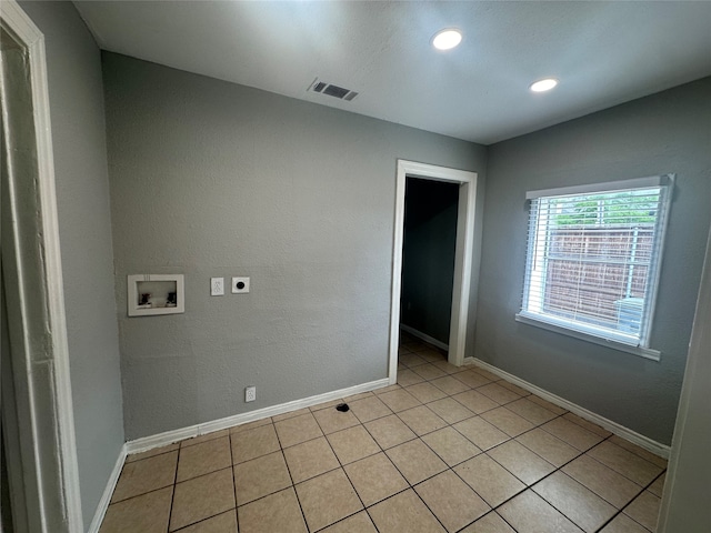 laundry area featuring washer hookup, hookup for an electric dryer, and light tile patterned floors