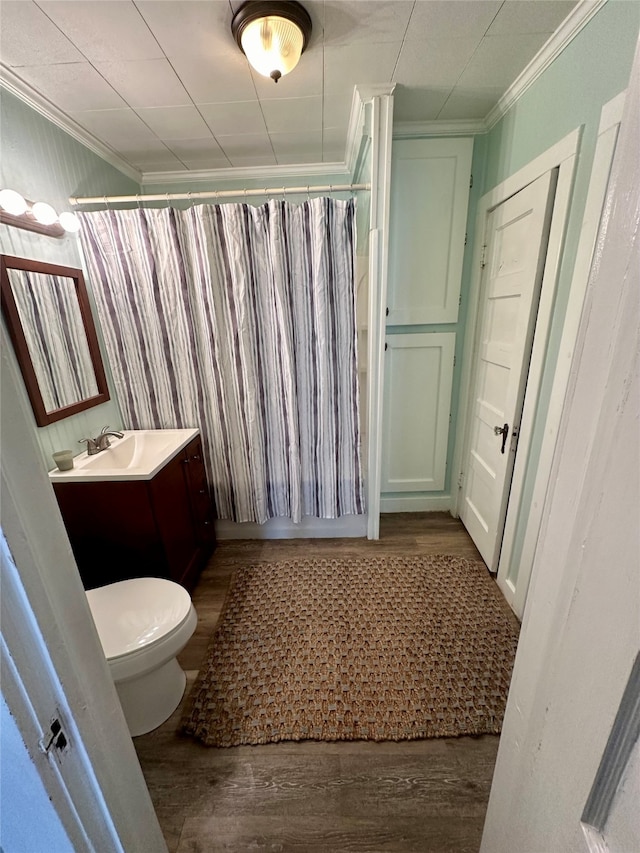 full bathroom featuring vanity, crown molding, hardwood / wood-style flooring, and toilet