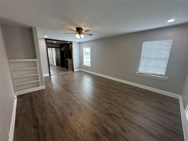 interior space with ceiling fan and dark wood-type flooring