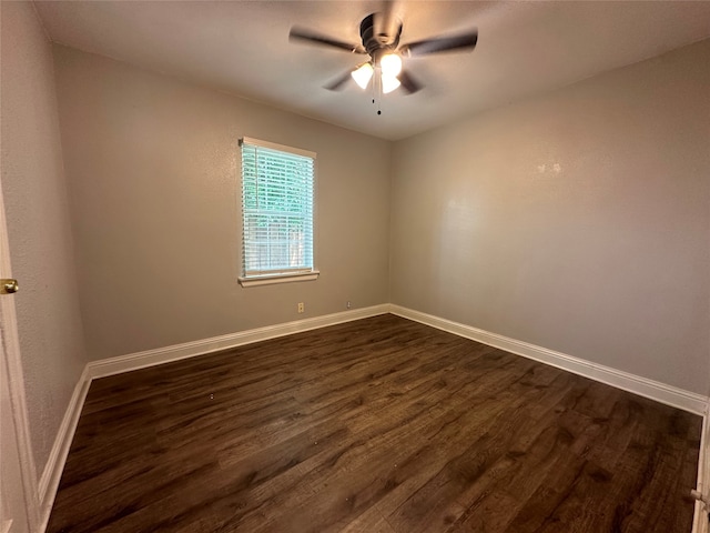 unfurnished room with ceiling fan and dark wood-type flooring