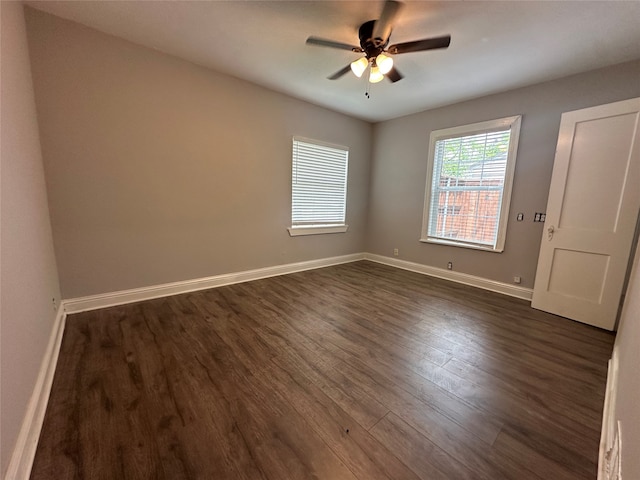 spare room featuring ceiling fan and dark hardwood / wood-style floors