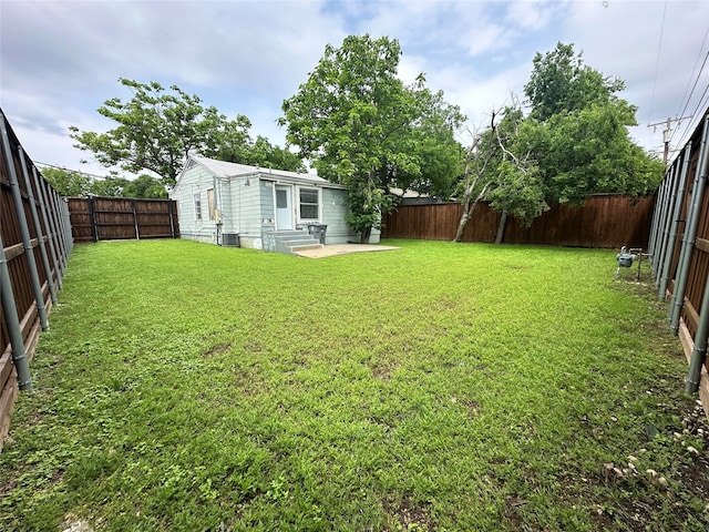 view of yard with a patio area and central air condition unit