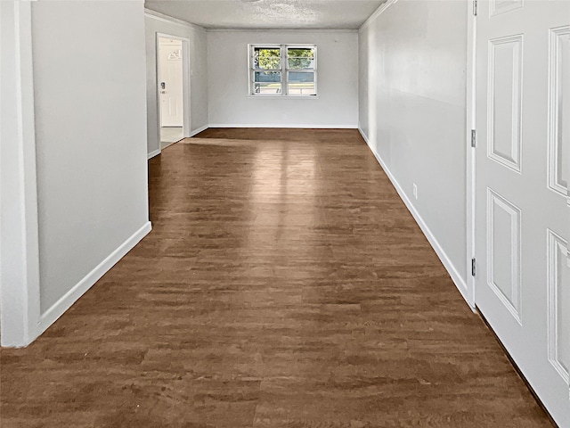 hallway with dark hardwood / wood-style floors and a textured ceiling