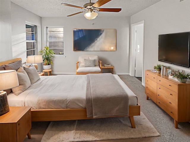 bedroom with a textured ceiling and ceiling fan