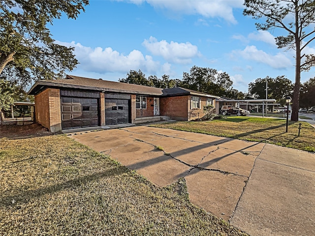 ranch-style home with a front lawn and a garage