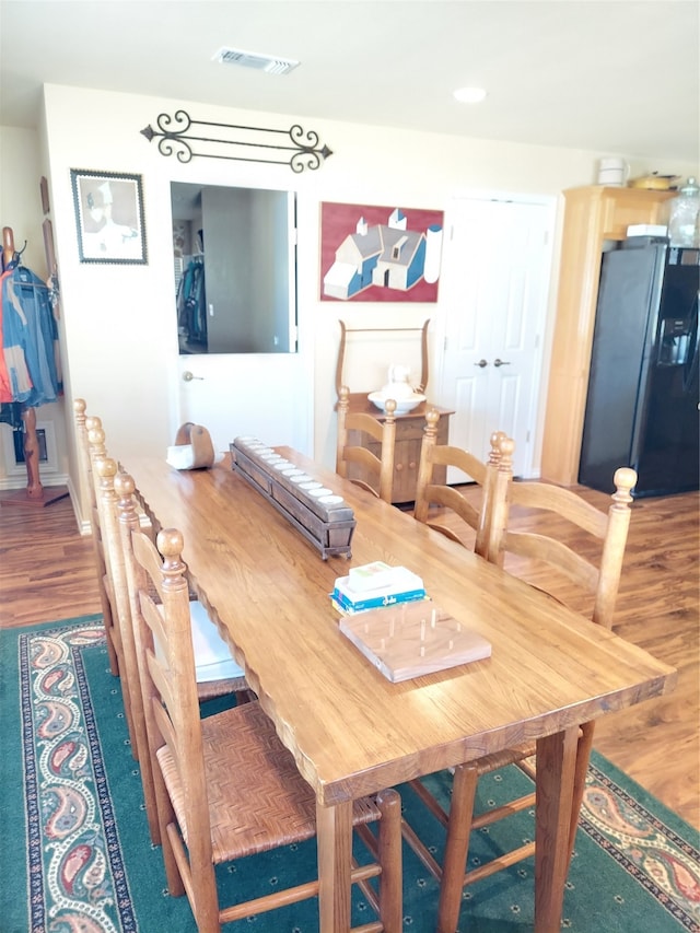 dining space with dark hardwood / wood-style floors