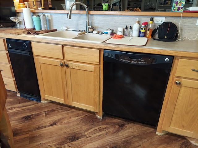 kitchen featuring black dishwasher, sink, light brown cabinets, and dark hardwood / wood-style floors