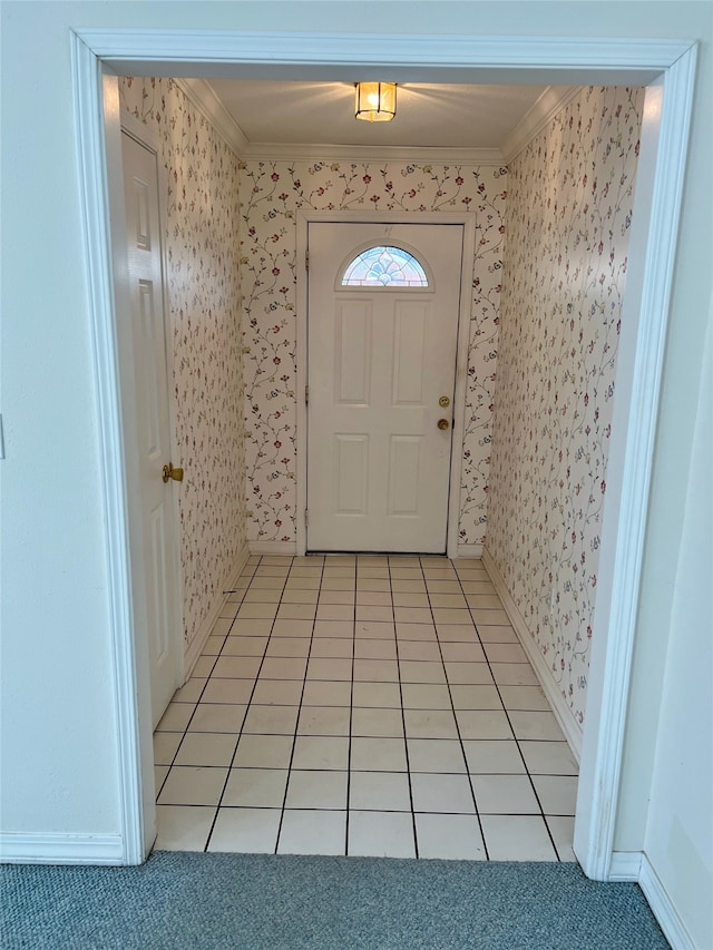 entryway with light tile patterned flooring and ornamental molding