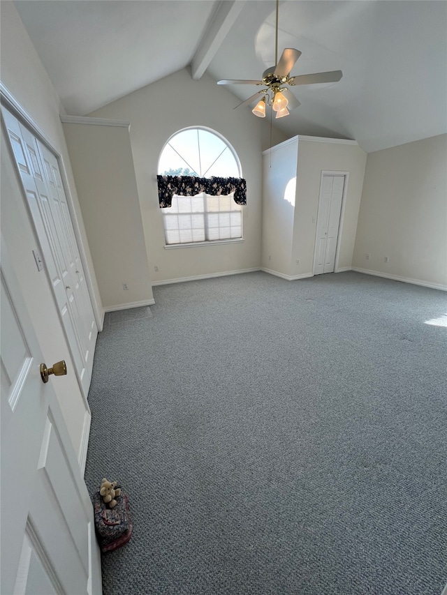 unfurnished bedroom featuring ceiling fan, vaulted ceiling with beams, and carpet flooring