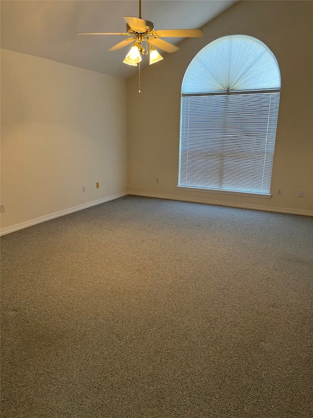 unfurnished room featuring lofted ceiling, ceiling fan, and carpet