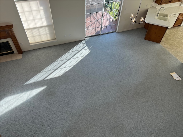 unfurnished living room with carpet floors and a tile fireplace